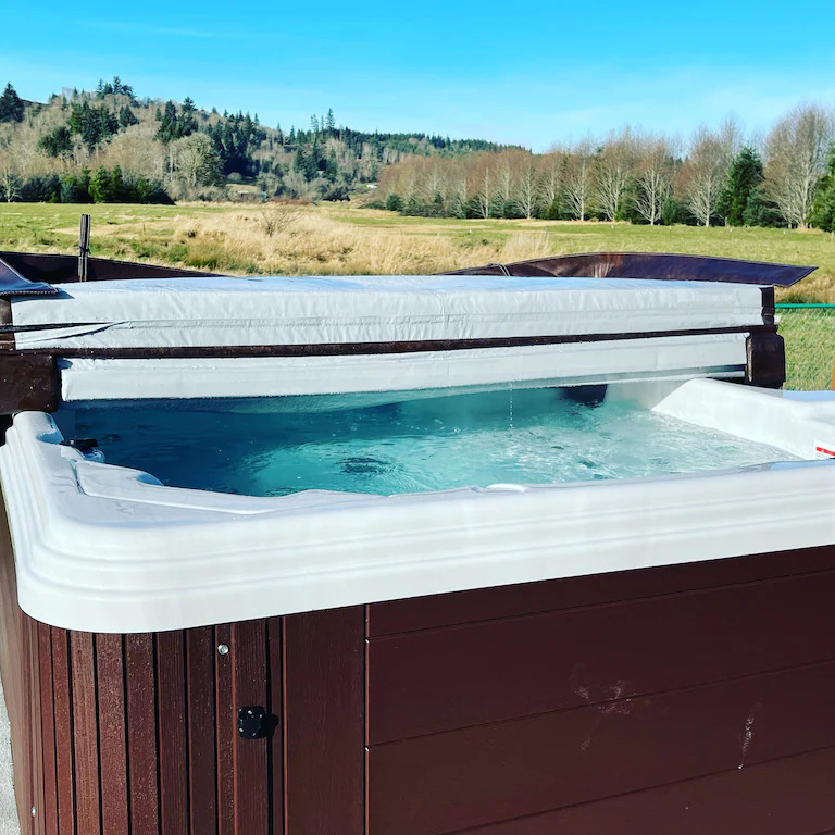 A hot tub with a view of the countryside.