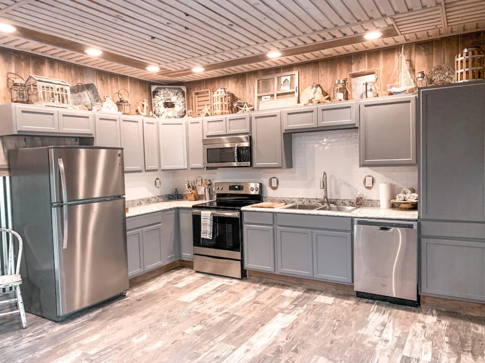 A kitchen with stainless steel appliances and wooden cabinets.