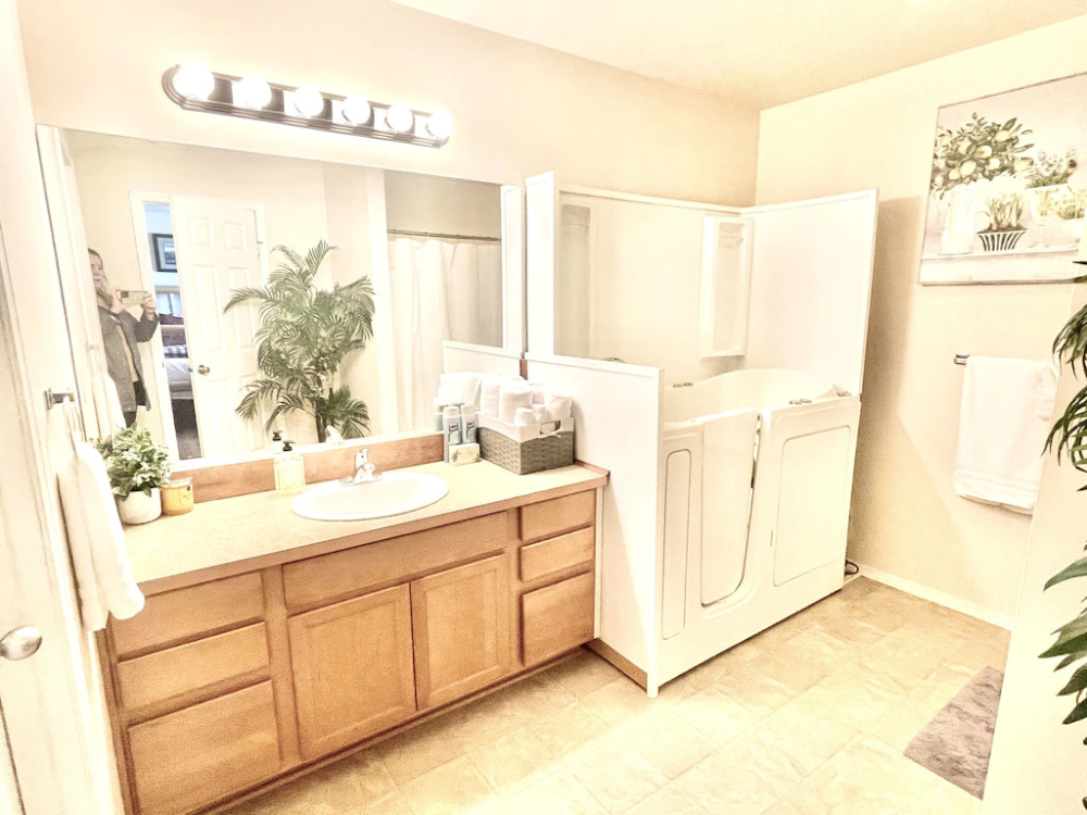 A kitchen with white appliances and wooden cabinets.