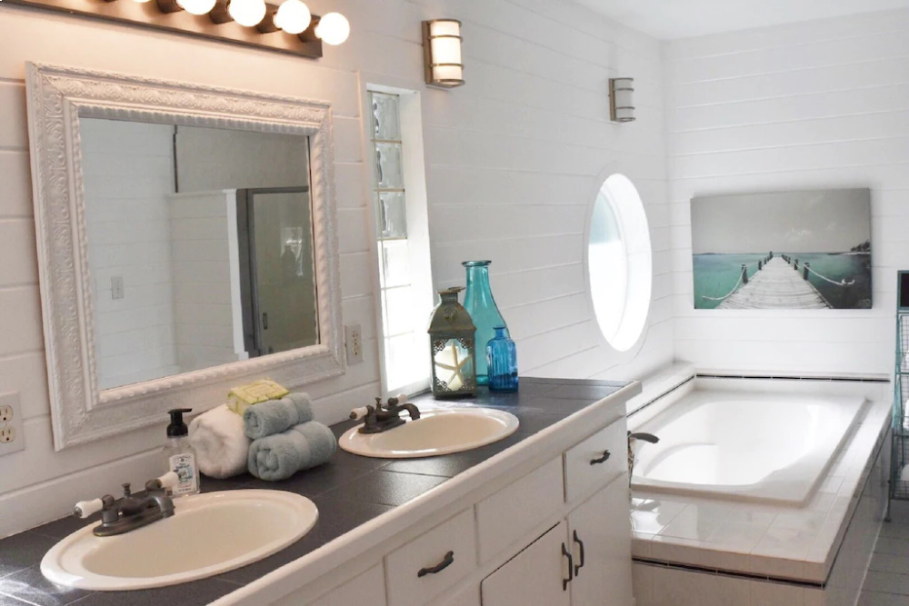 A bathroom with two sinks and a mirror.