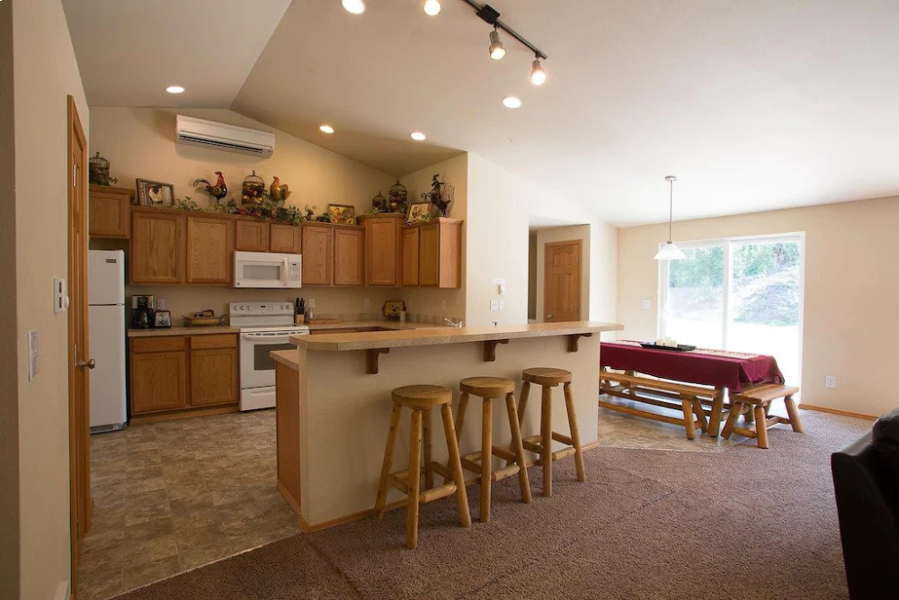 A kitchen with a bar and stools in it