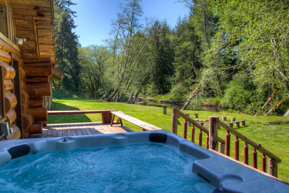 A hot tub sitting on top of a wooden deck.